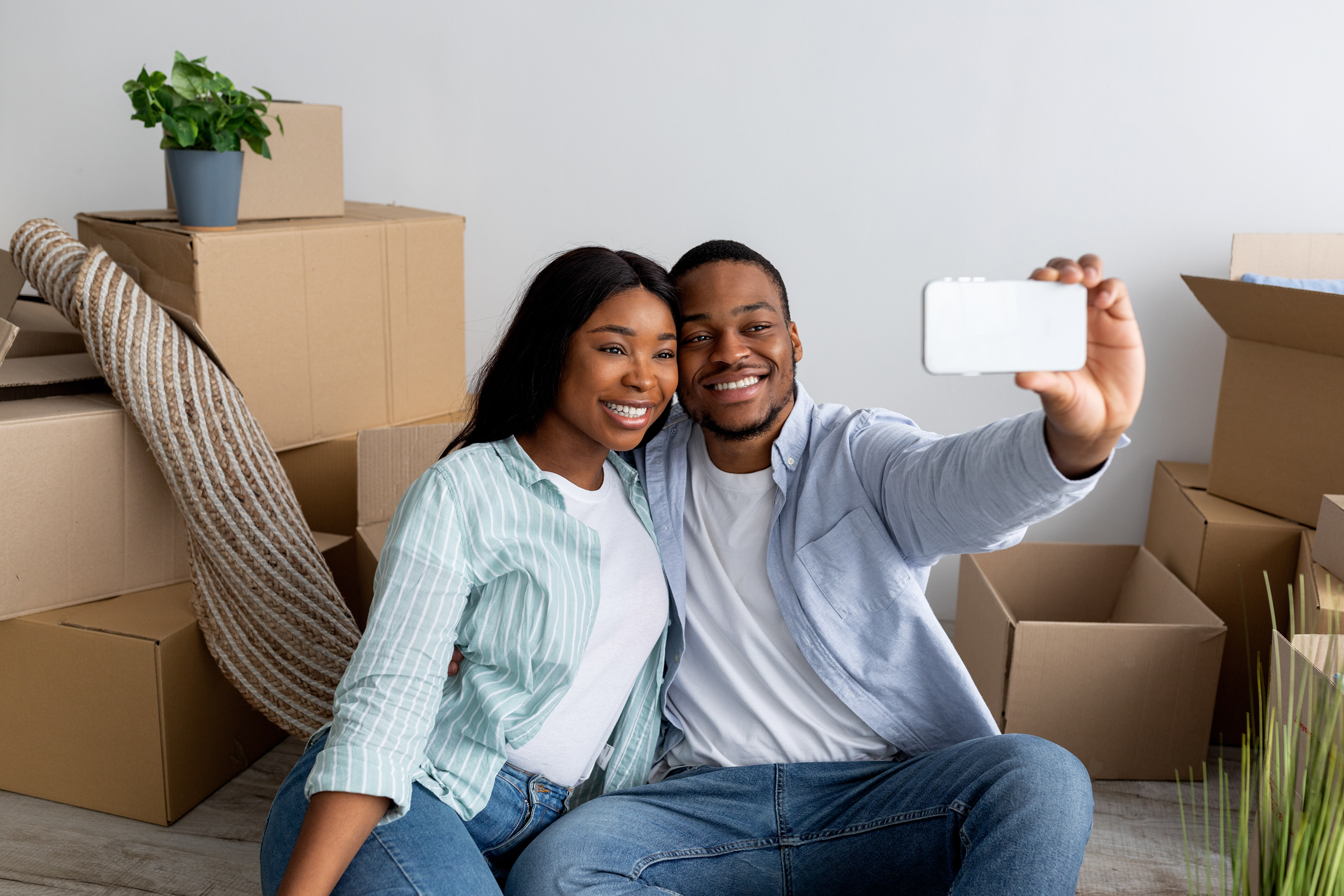 Happy couple taking a selfie in their house